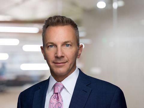 James F. Glunt seen posing for a photo in a dark blue color suit